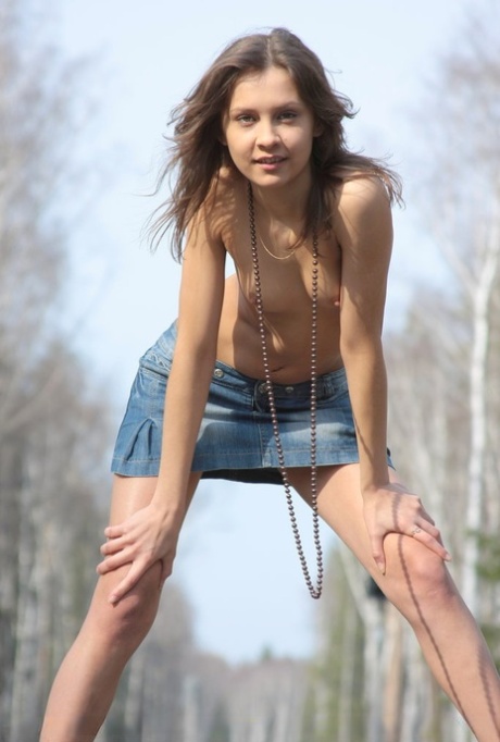 Charming teen Lina G doffs a denim mini-skirt to pose nude on railway tracks