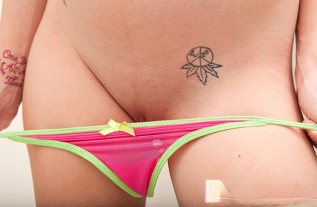 Pregnant cutie slips off her lingerie before applying baby oil in a shower