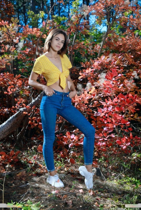 Hot teen Dzhili fondles her great body after getting naked near a fallen tree